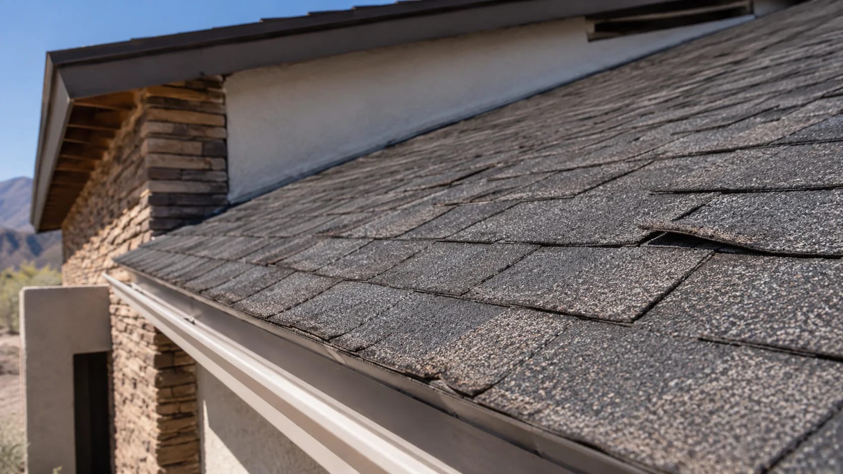 Aging asphalt shingles with granule loss and lifted edges