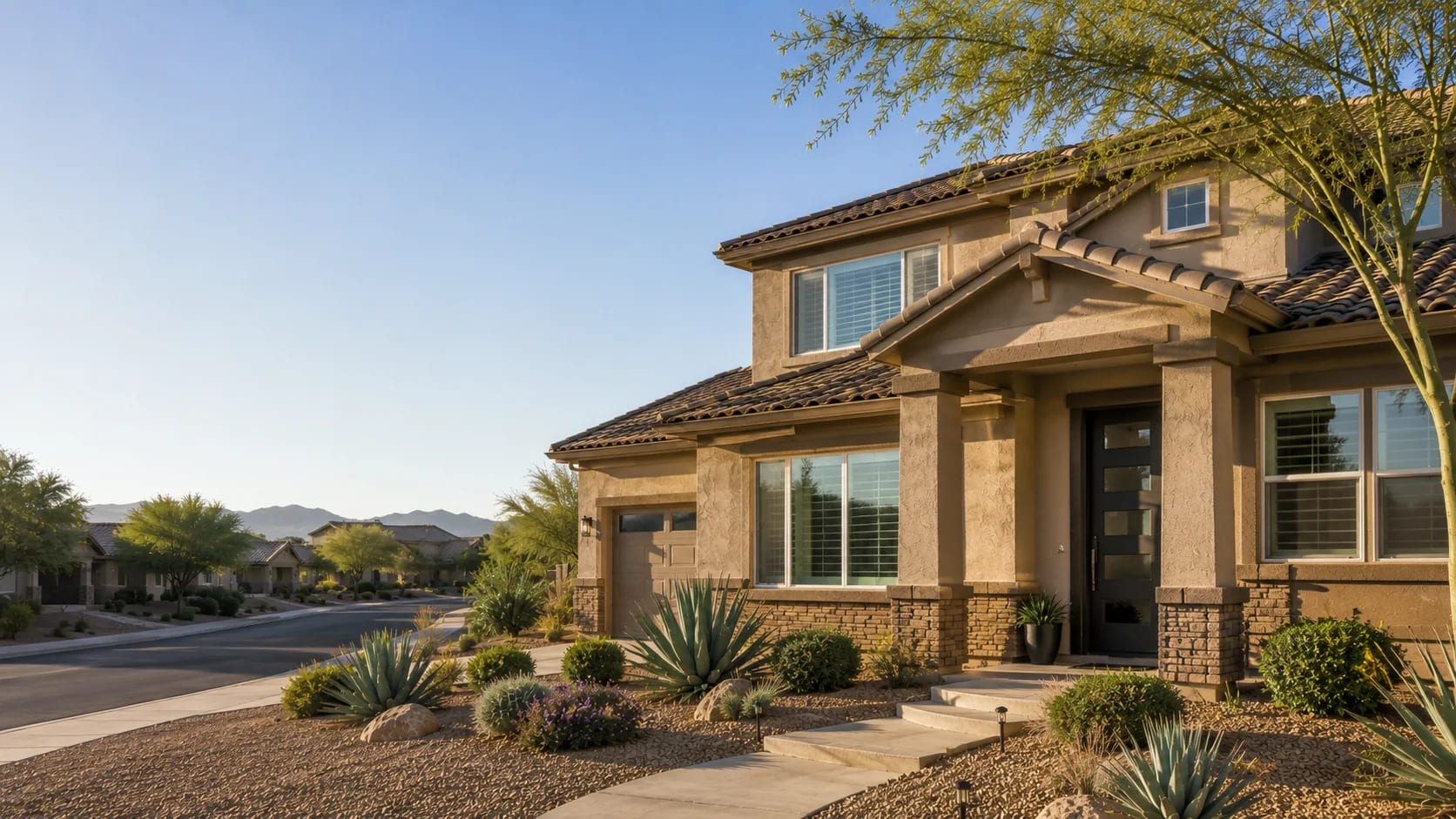 Two-story Anthem, Arizona home with a covered entry and desert landscaping