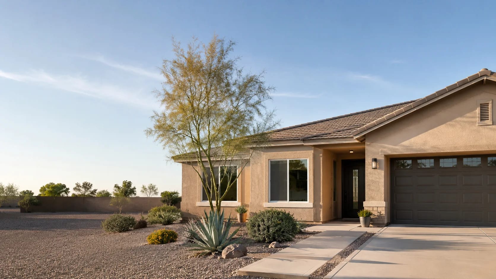 Single-story El Mirage, Arizona home with a tile roof and desert landscaping
