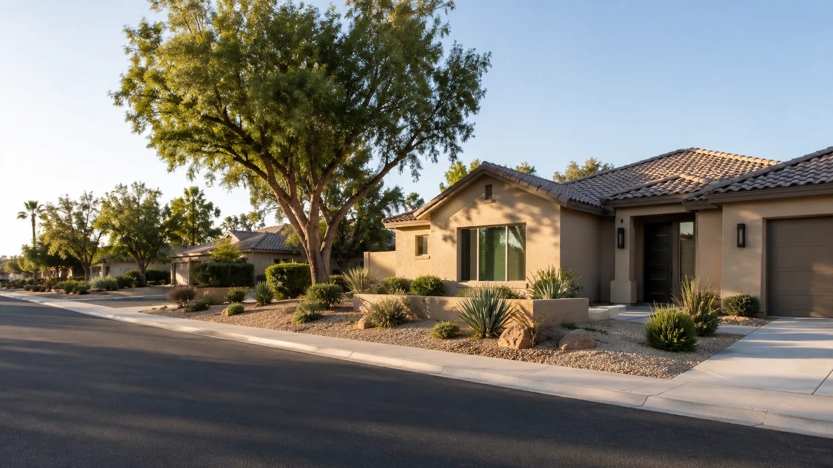 Single-story Glendale, Arizona home on a tree-lined street with desert landscaping