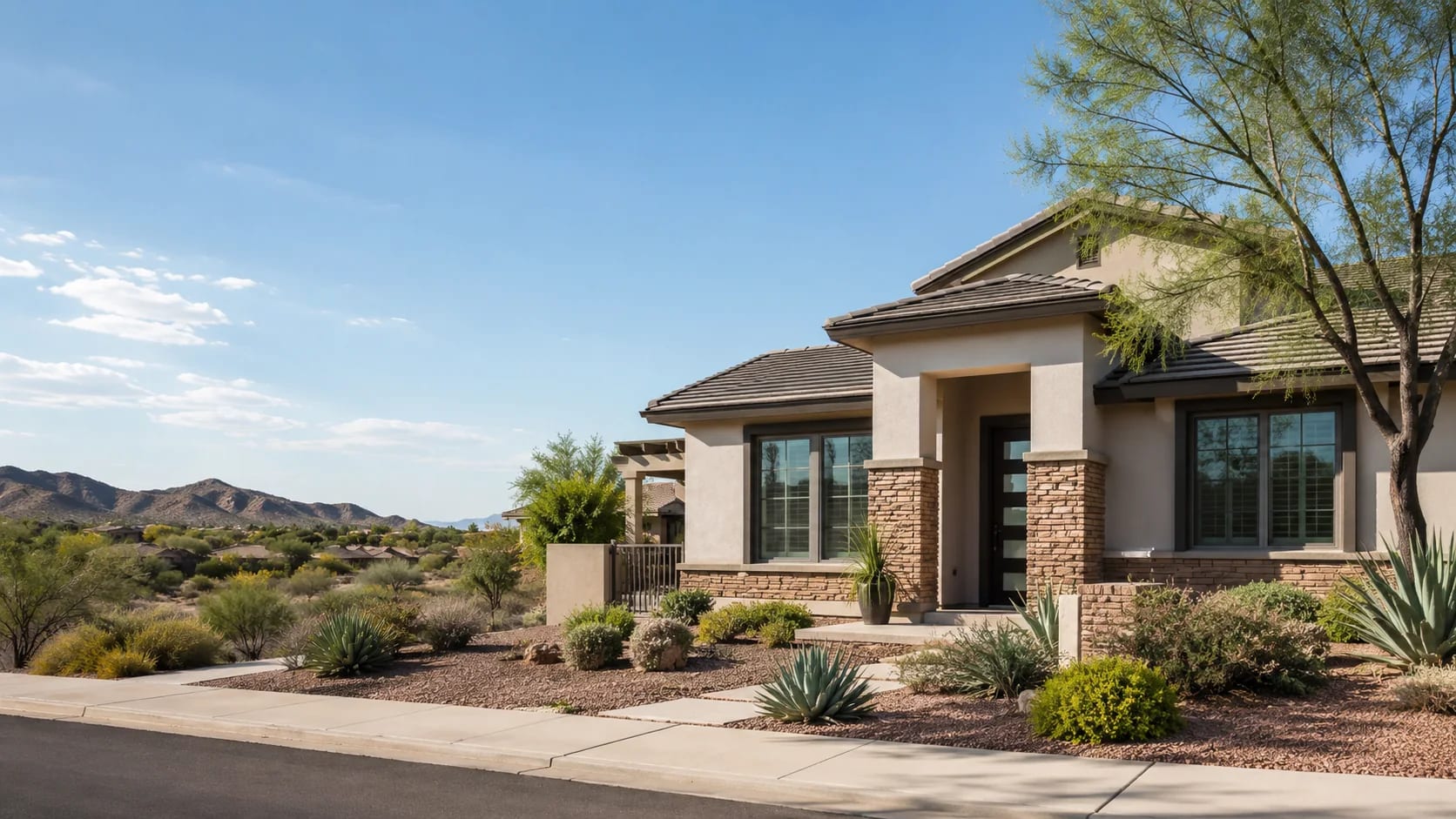 Single-story Peoria, Arizona home with desert landscaping and mountain views
