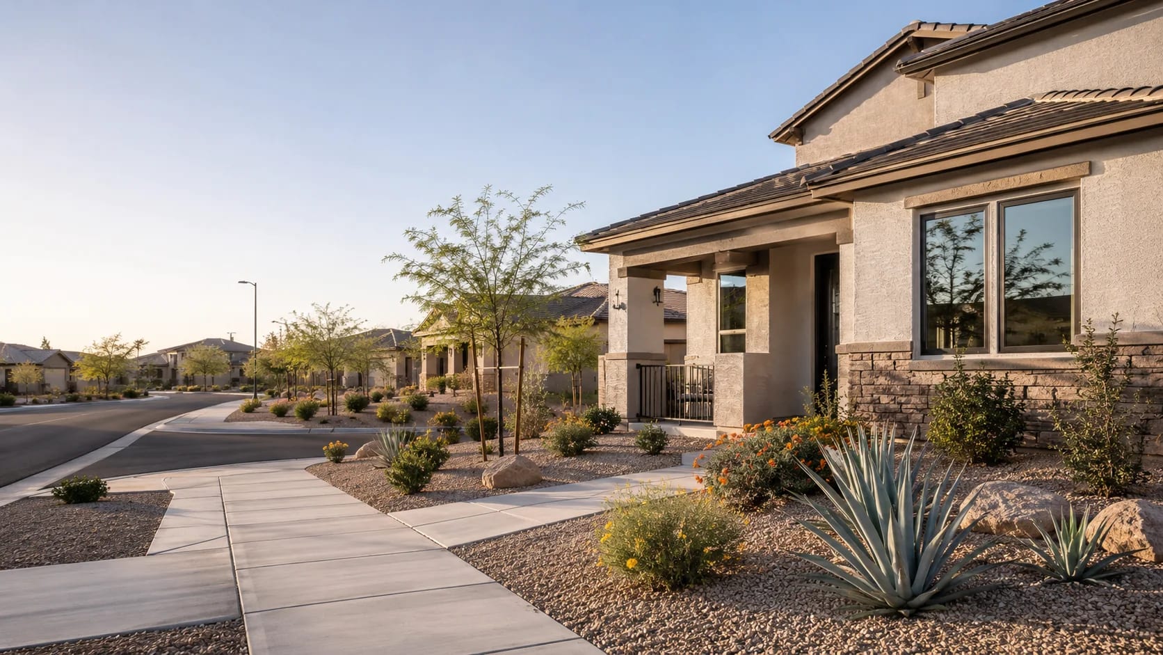 Surprise, Arizona home with large windows, a covered entry, and desert landscaping